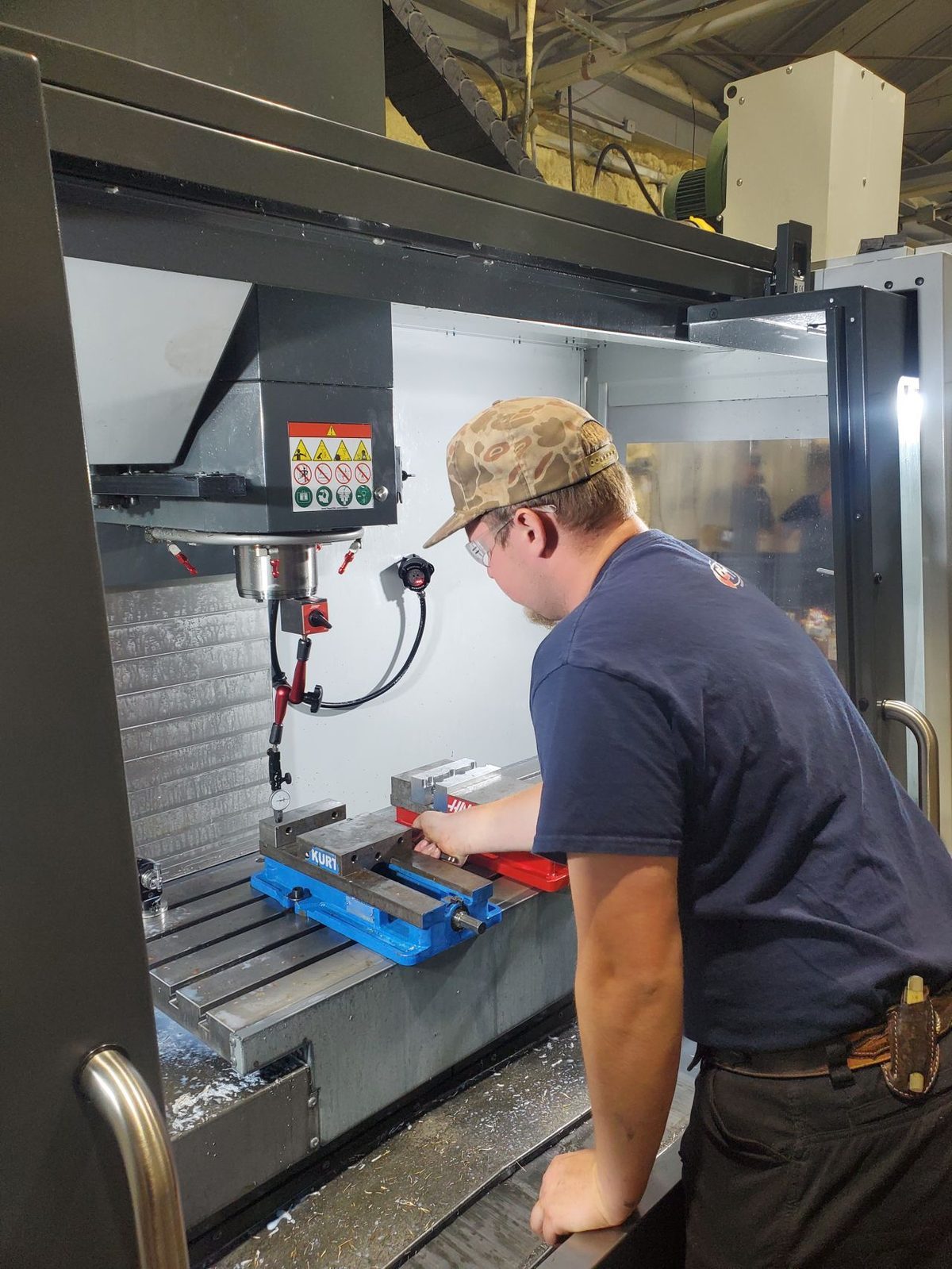 PH machinist running a CNC mill at the Lake Charles shop